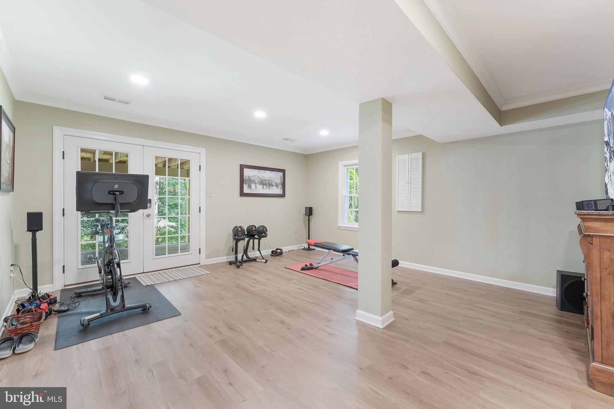 1248 Lamplighter Way Reston, VA 20194 - Photo 41 of 64 a view of a room with gym equipment and a flat screen tv
