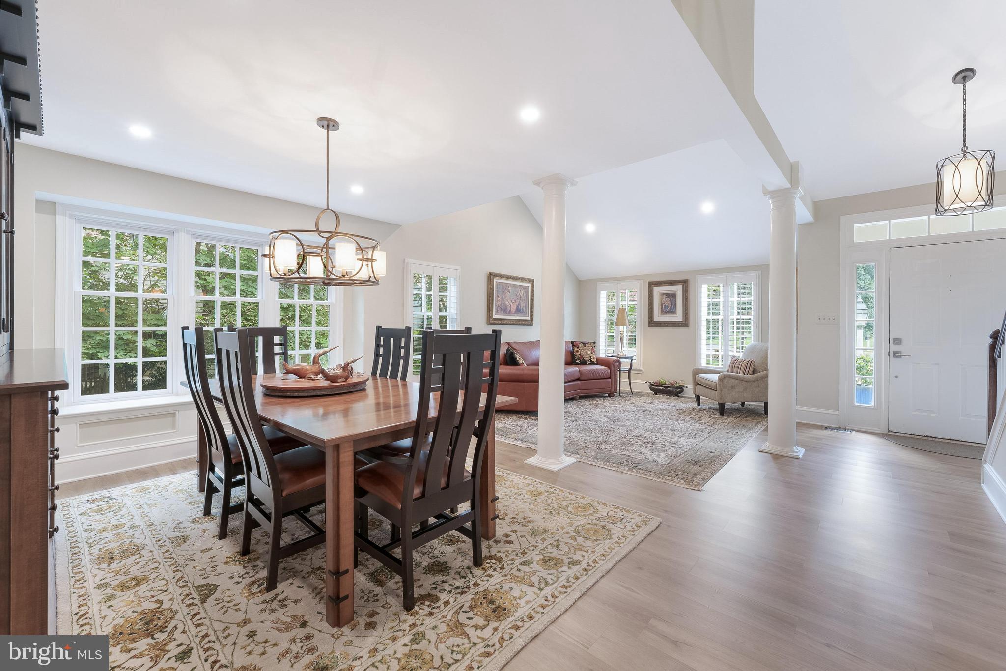 1248 Lamplighter Way Reston, VA 20194 - Photo 10 of 64 a view of a dining room and livingroom with furniture wooden floor a chandelier
