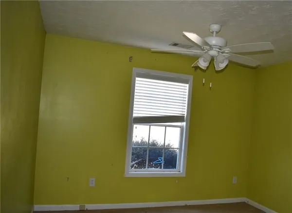 a view of a room with window and ceiling fan