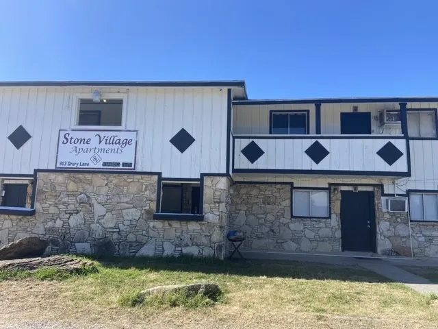 a brick building with a sink in front of it