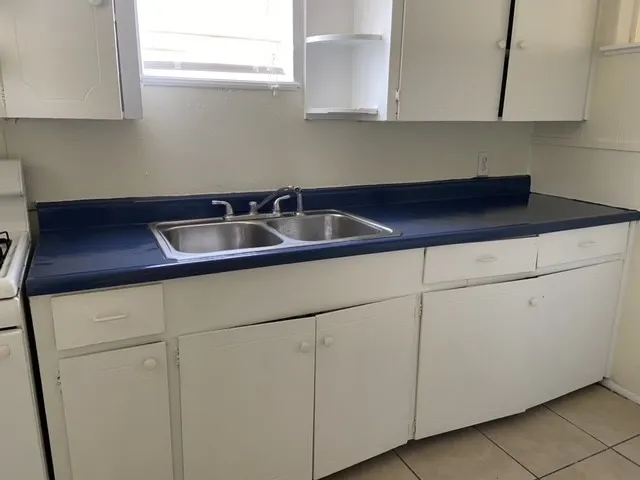 a kitchen with a sink and cabinets