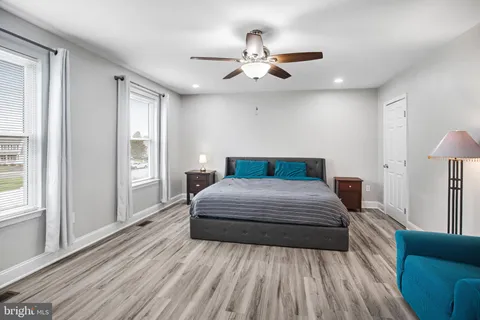 a bedroom with a large bed and a chandelier