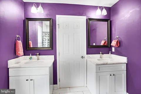 a bathroom with a sink vanity and a mirror