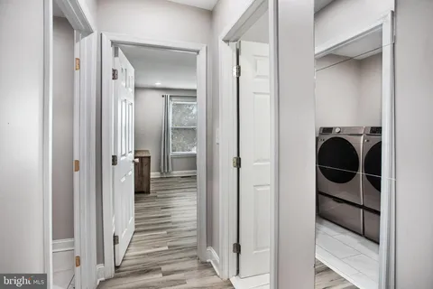 a view of a hallway view with wooden floor and staircase