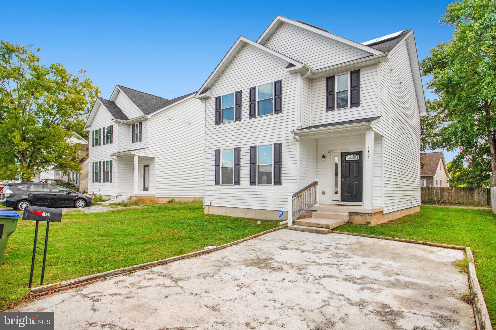 2452 24th Street Fredericksburg, VA 22408 - Photo 2 of 30 a front view of a house with a yard and garage