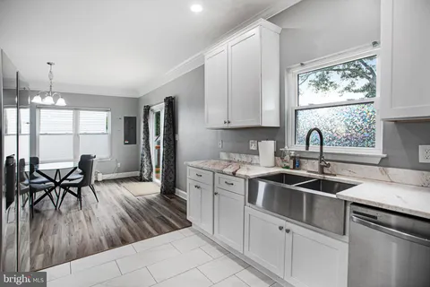 a kitchen with a sink window and cabinets