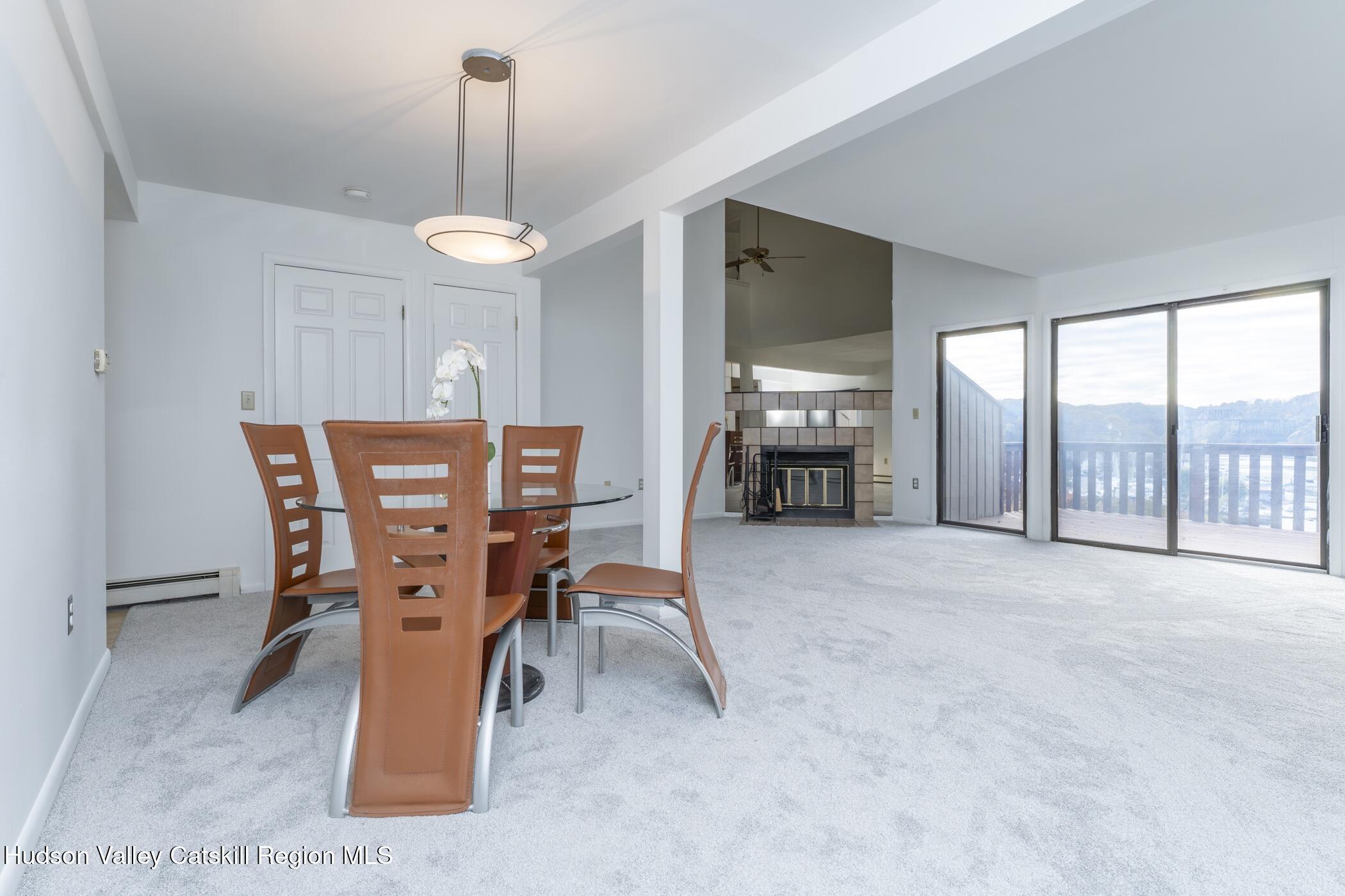34 Rondout Harbor Port Ewen, NY 12466 - Photo 13 of 42 a dining room with furniture water view and a floor to ceiling window