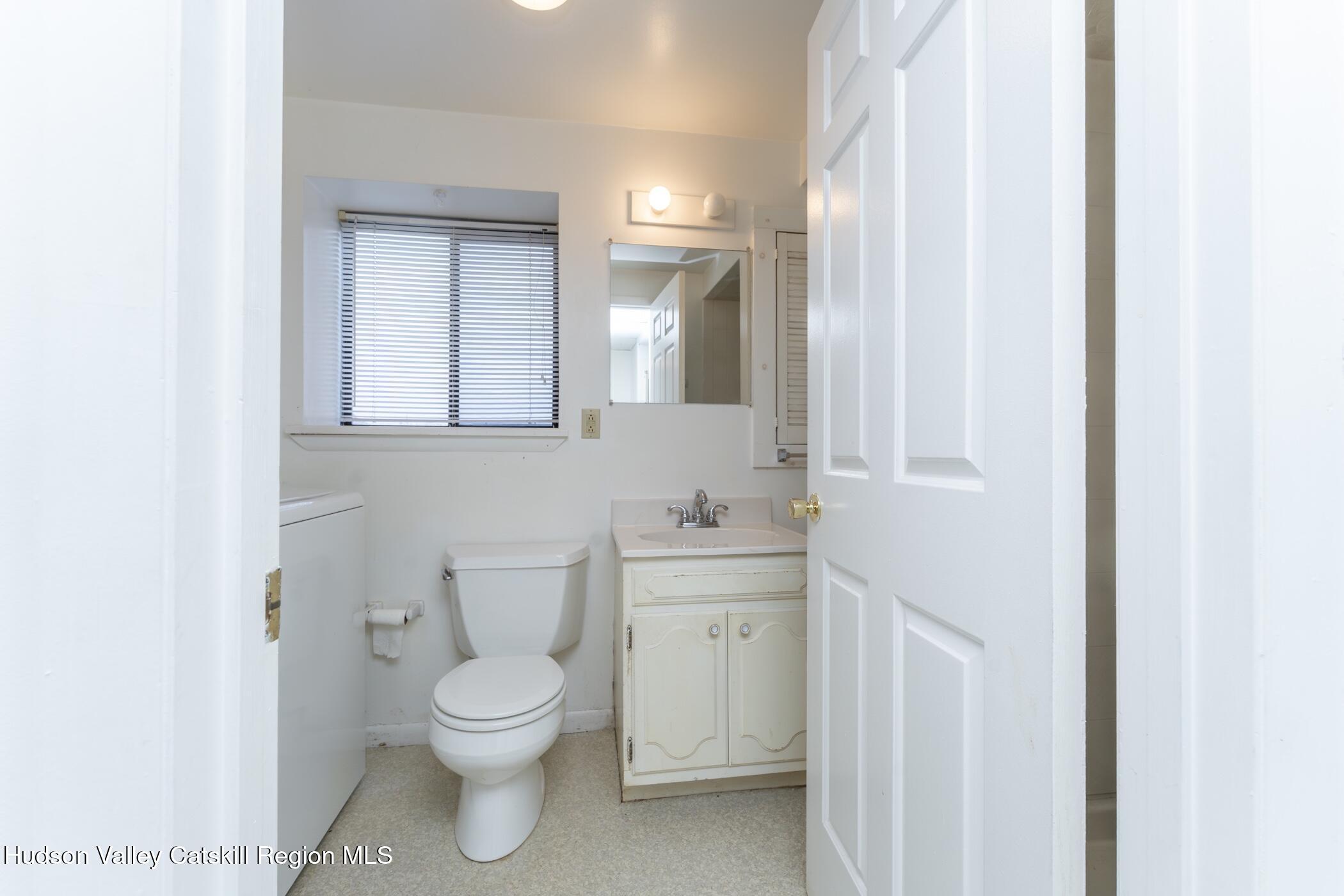 34 Rondout Harbor Port Ewen, NY 12466 - Photo 30 of 42 a bathroom with a toilet a sink and mirror