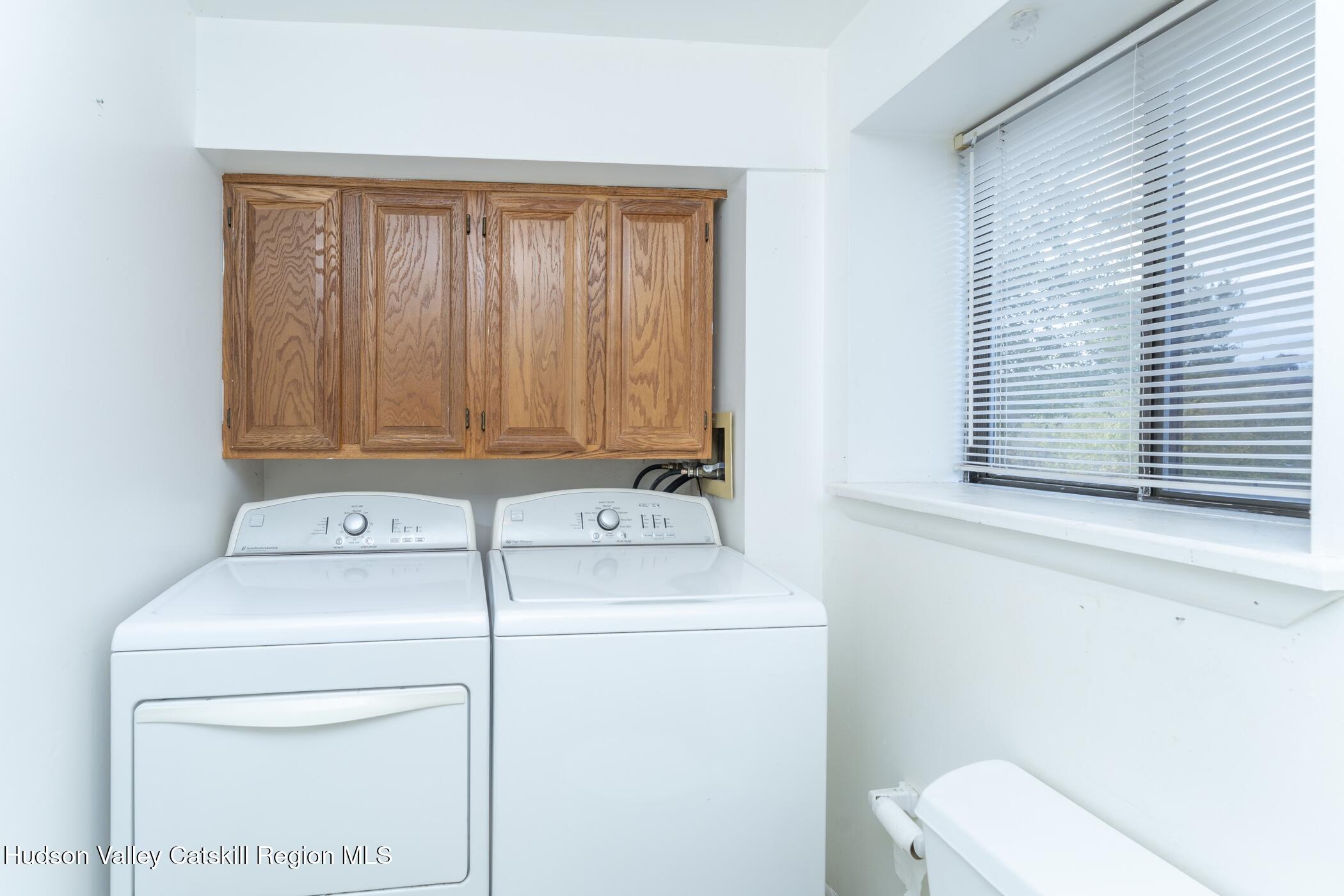 34 Rondout Harbor Port Ewen, NY 12466 - Photo 31 of 42 a bathroom with a sink a toilet and a shower curtain