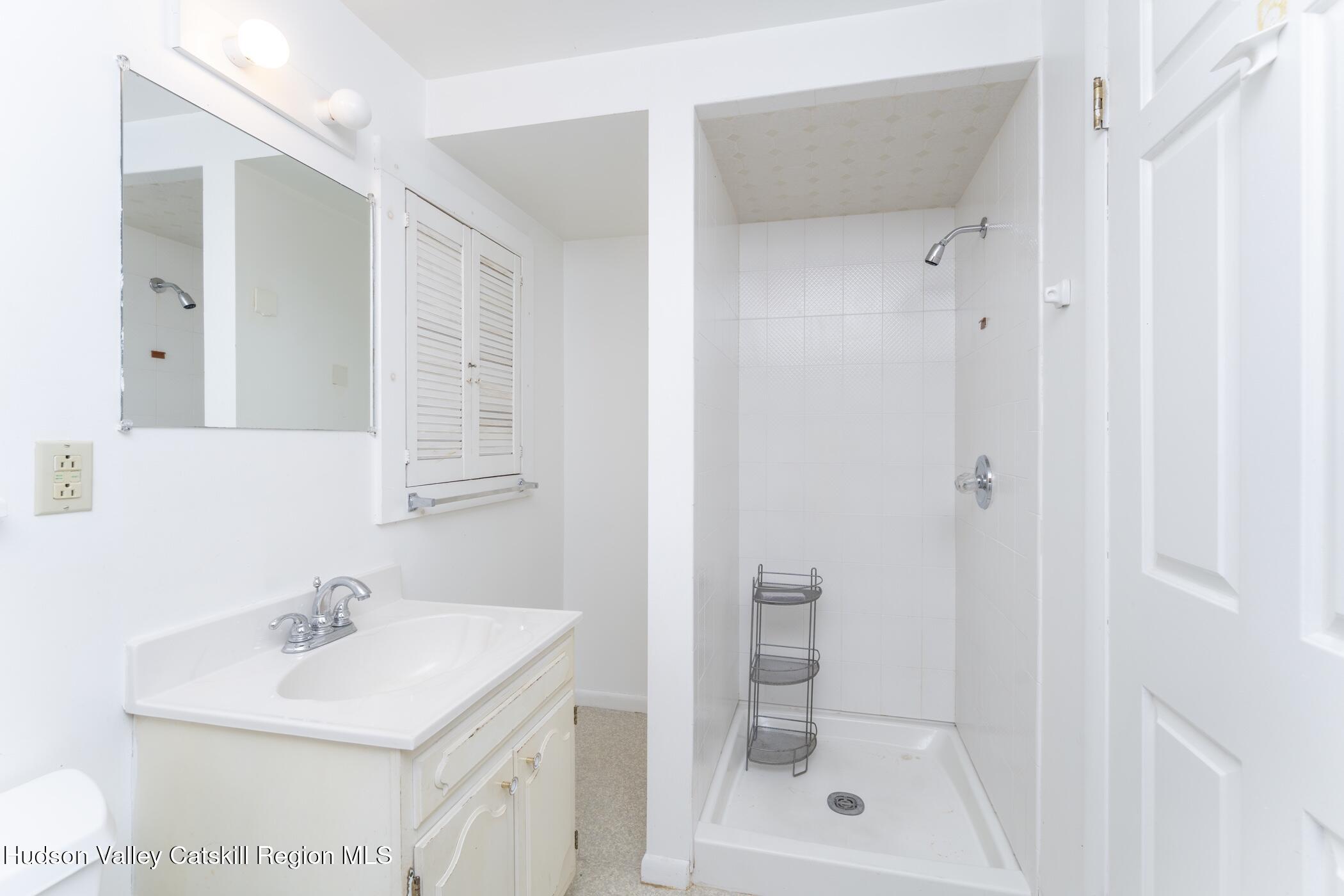 34 Rondout Harbor Port Ewen, NY 12466 - Photo 32 of 42 a bathroom with a sink mirror and shower