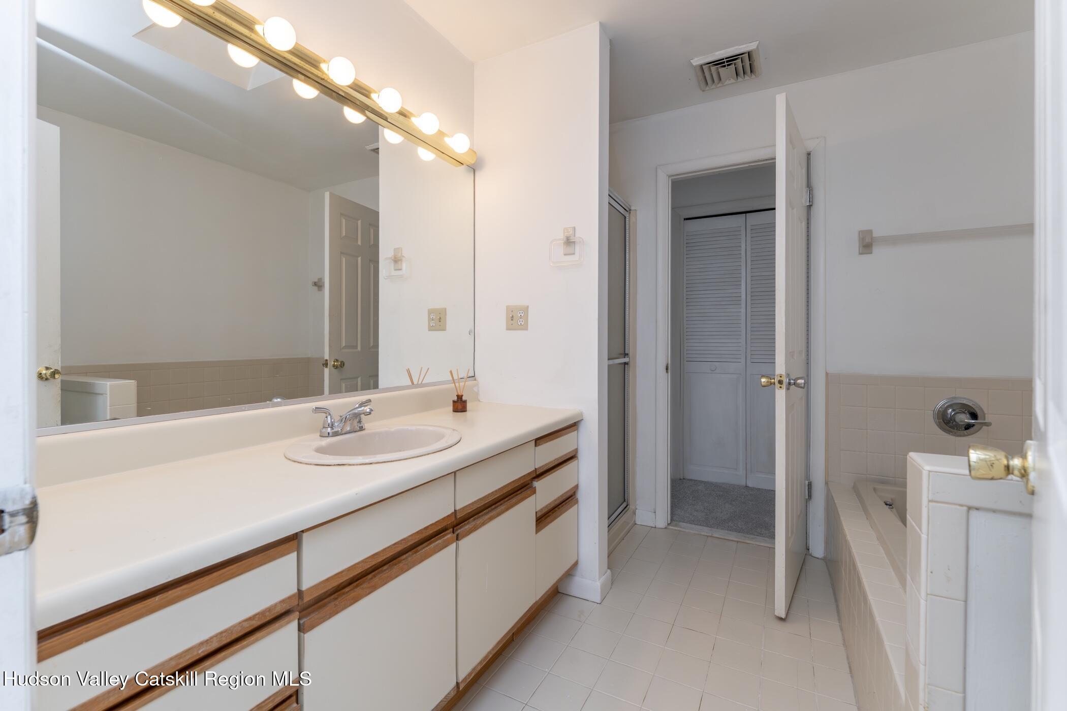 34 Rondout Harbor Port Ewen, NY 12466 - Photo 37 of 42 a spacious bathroom with a double vanity sink and mirror