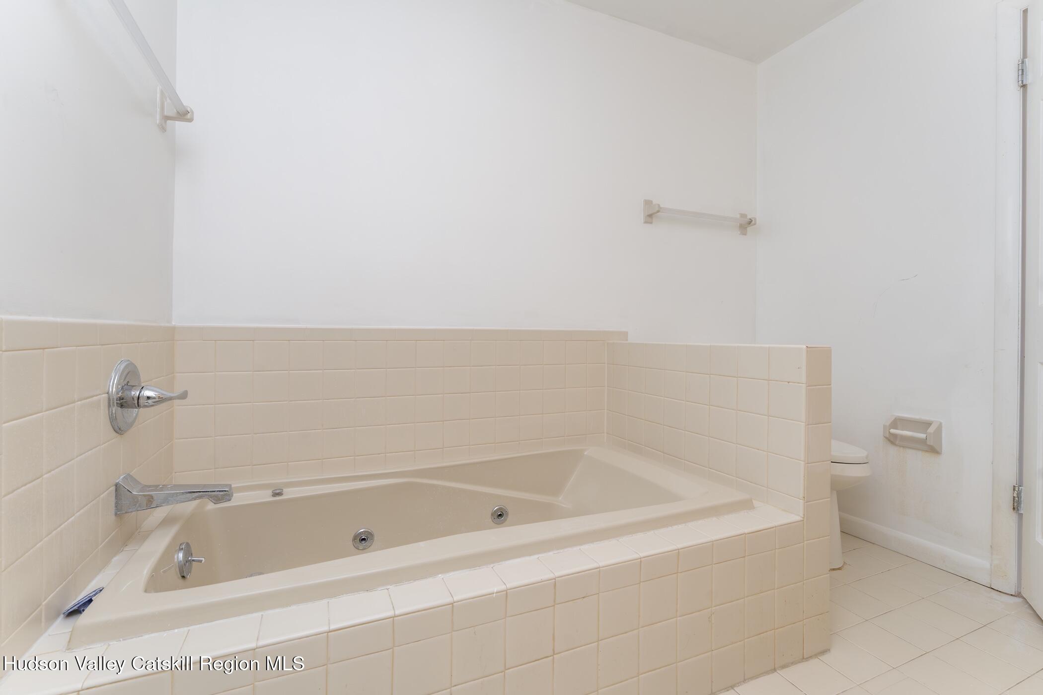 34 Rondout Harbor Port Ewen, NY 12466 - Photo 39 of 42 a white bath tub sitting next to a white sink and vanity