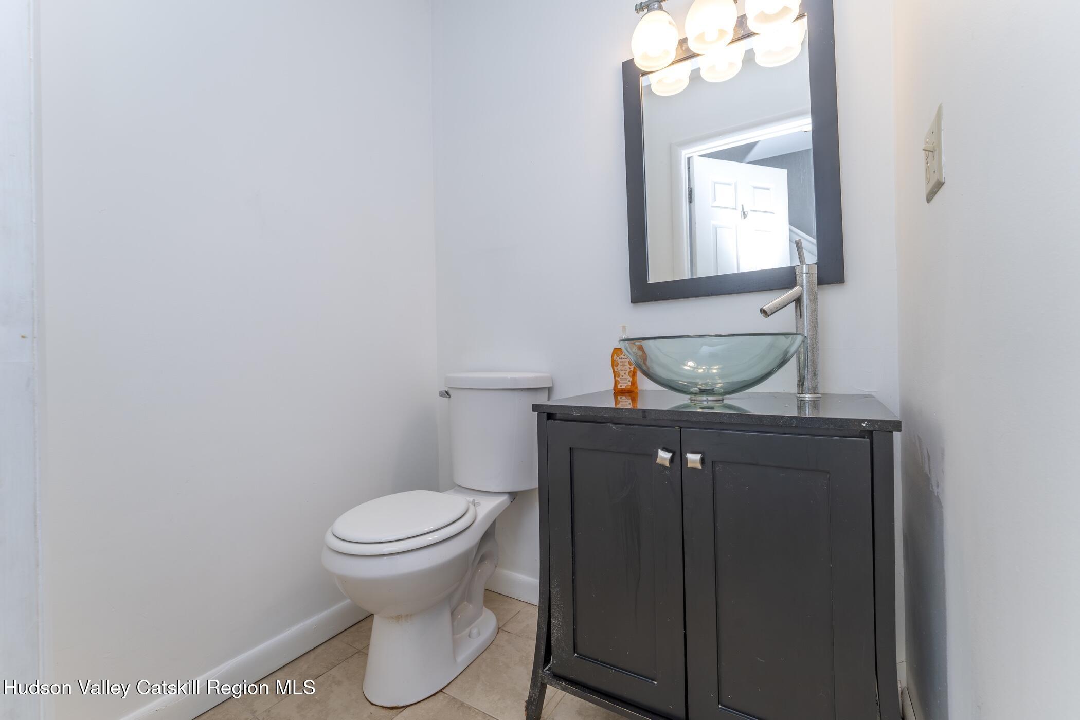 34 Rondout Harbor Port Ewen, NY 12466 - Photo 6 of 42 a bathroom with a toilet sink and mirror