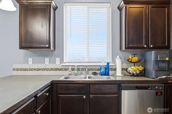 a kitchen with a sink cabinets and window
