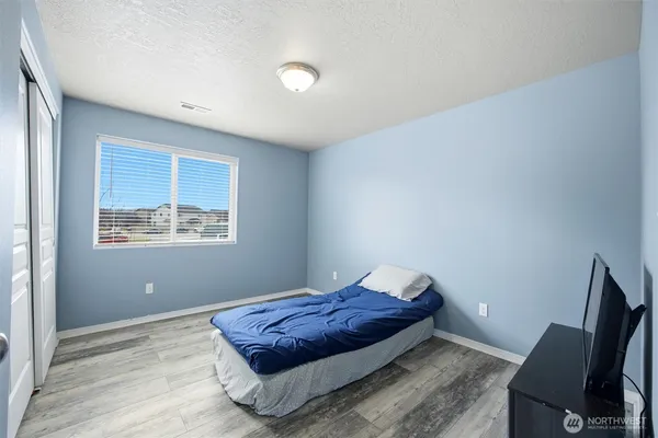 a spacious bedroom with a bed and window