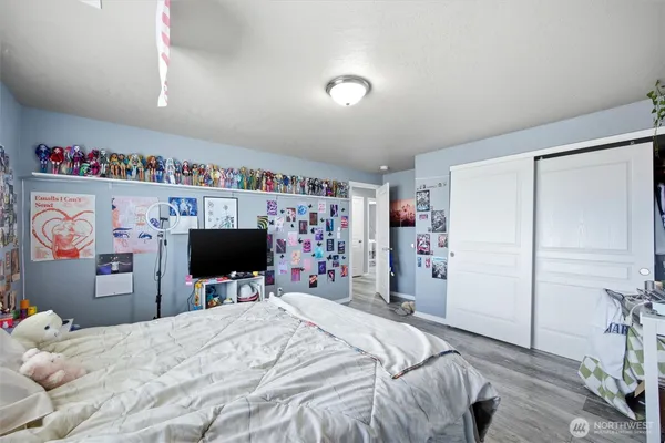 a bed room with a bed and a flat screen tv