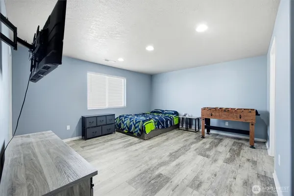 a bedroom with a bed and a chair