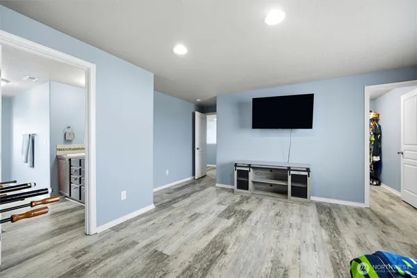 a view of a livingroom with furniture and a flat screen tv