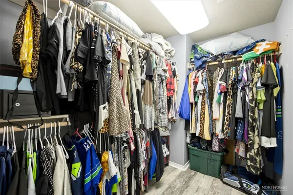 a view of walk in closet with clothes