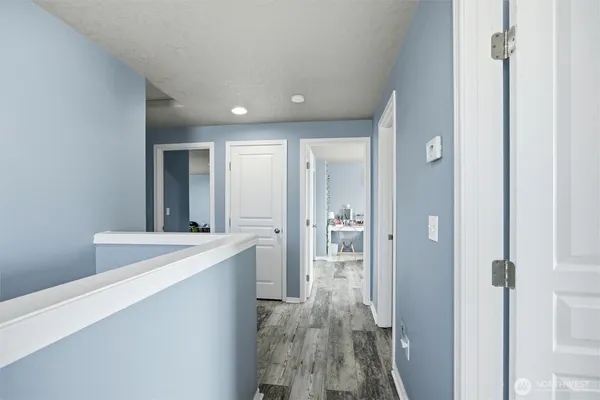 a large kitchen with a sink and refrigerator