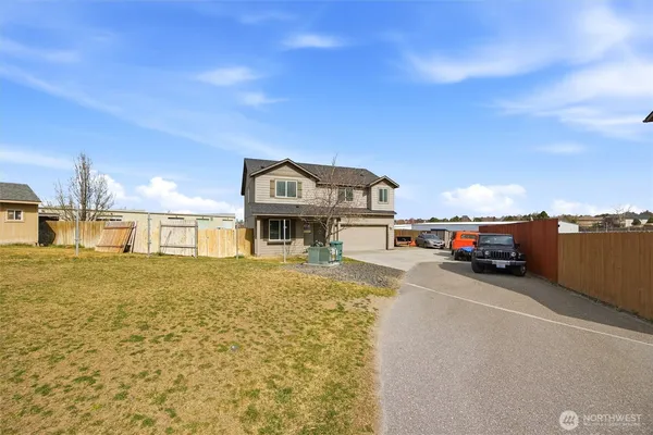 a view of a street that has couple of cars parked in front of it