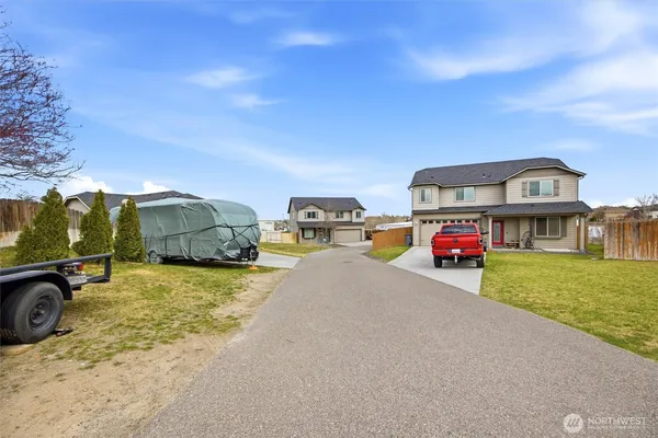 a view of a cars park in front of a house