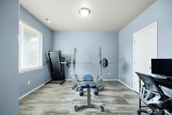a view of a workspace with furniture and a window