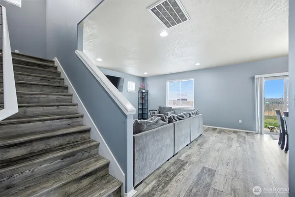 a view of a kitchen with wooden floor and electronic appliances
