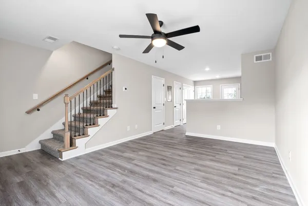 a view of an entryway with wooden floor