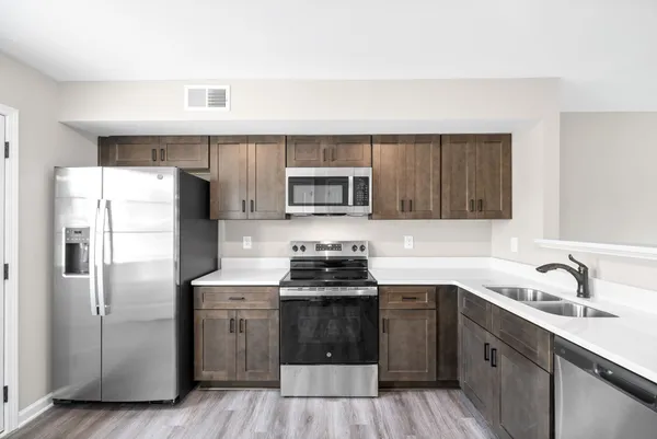 a kitchen with a sink stove and refrigerator