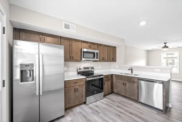 a kitchen with a sink stainless steel appliances and cabinets