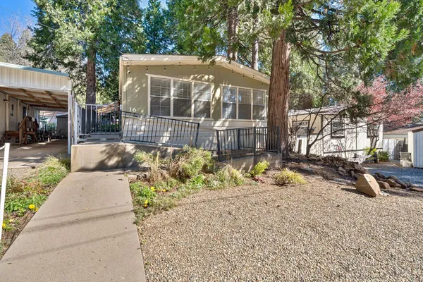 a view of a house with backyard and sitting area