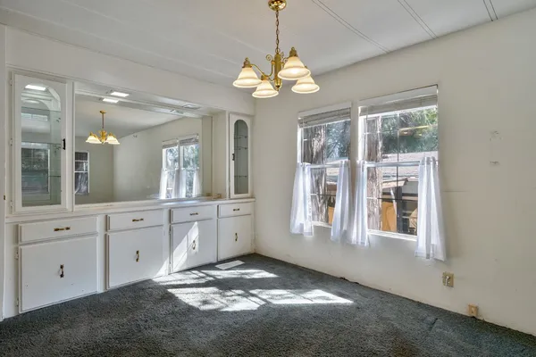 a spacious bathroom with a granite countertop sink a large mirror and a window