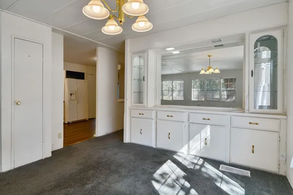 a living room with furniture and chandelier