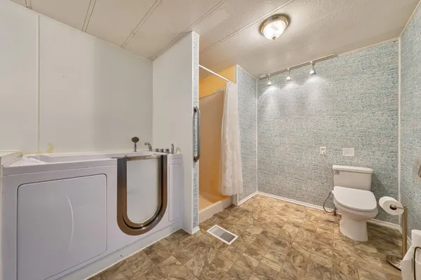 a bathroom with a toilet sink and shower