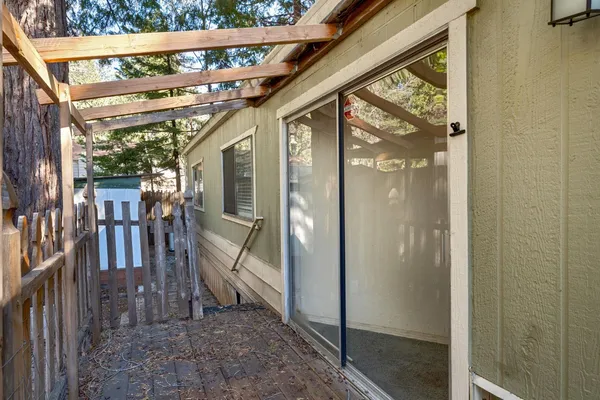 a view of a porch with wooden floor and stairs