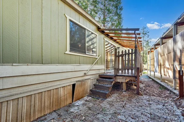 a view of a house with backyard and sitting area