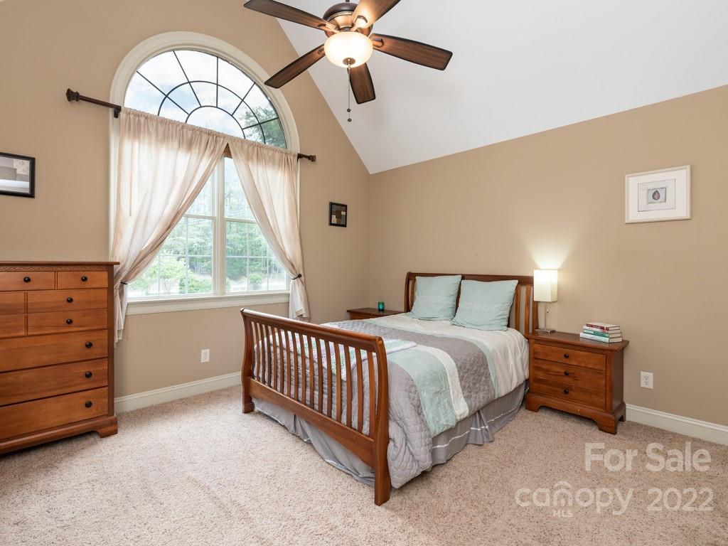 2367 Vineyard Road Fort Mill, SC 29708 - Photo 24 of 39 a spacious bedroom with a bed and a chandelier
