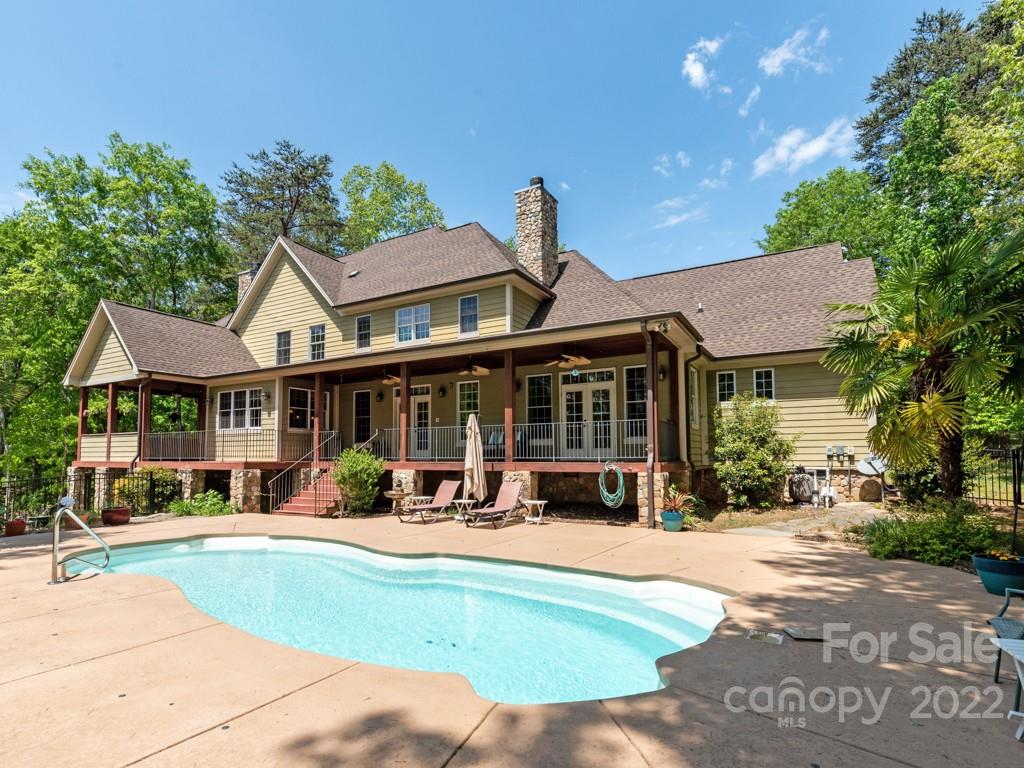 2367 Vineyard Road Fort Mill, SC 29708 - Photo 34 of 39 a view of a white house with large windows plants and palm trees
