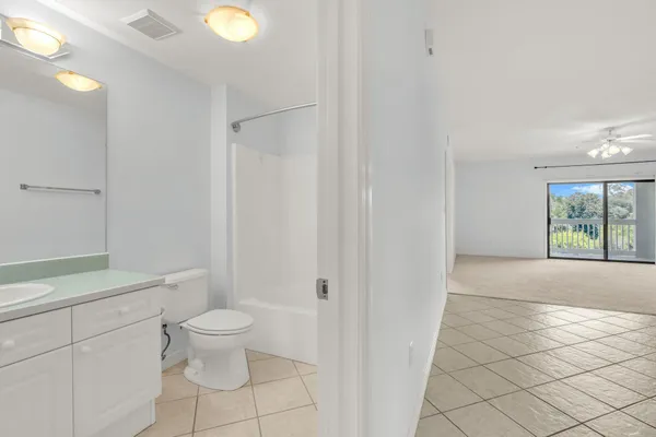 a bathroom with a toilet a sink and shower