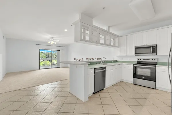 a kitchen with a stove a sink and a refrigerator
