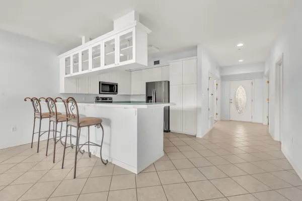 a open kitchen with cabinets and chairs