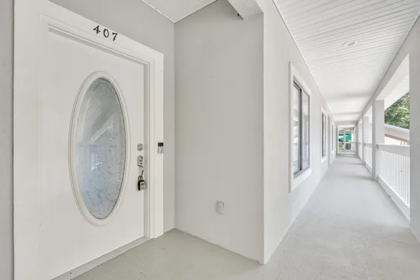 a view of a utility room with windows and closet