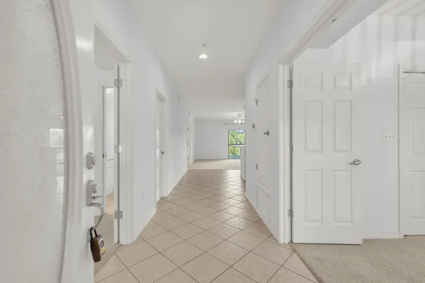 a view of a hallway with white doors