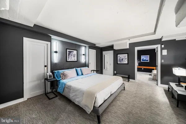 a bedroom with a large bed and a tv