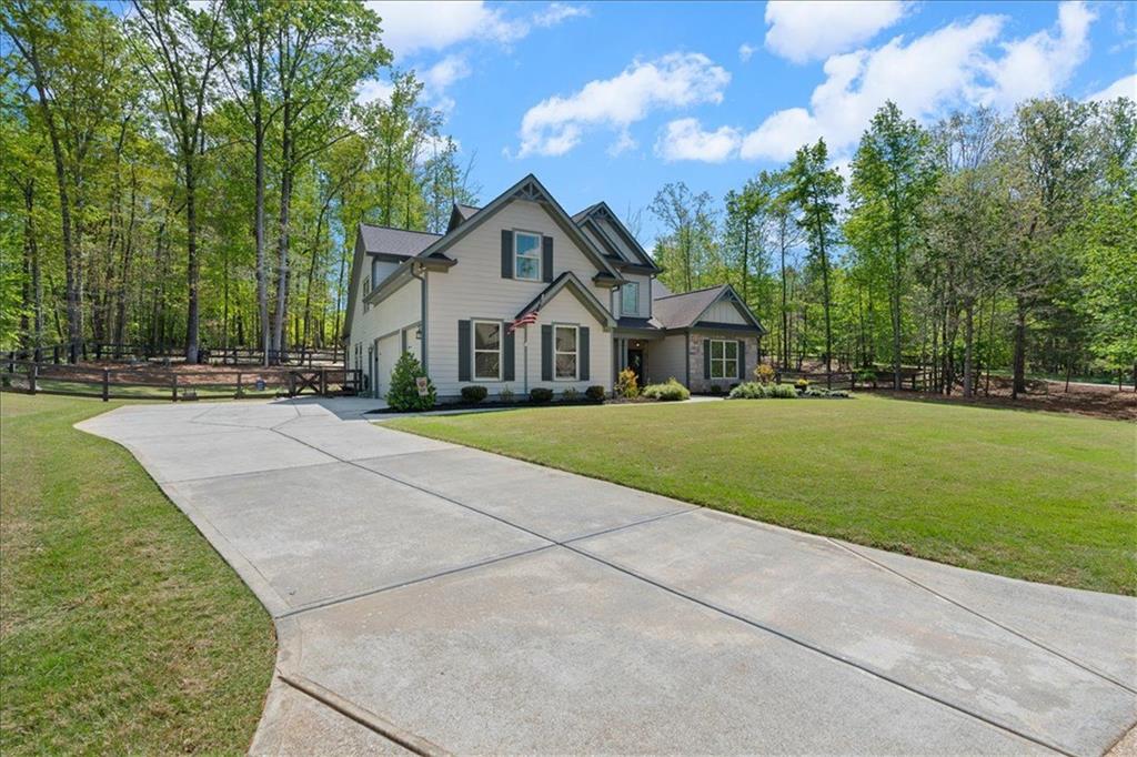 7610 Scenic Overlook Cumming, GA 30041 - Photo 8 of 62 a front view of a house with a yard and trees