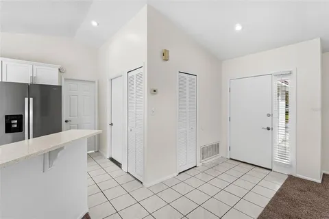 a view of a kitchen with a refrigerator and a sink