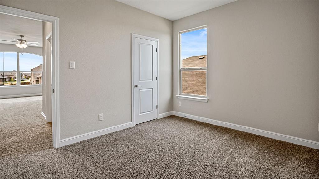 105 Hugo Court Rhome, TX 76078 - Photo 26 of 40 an empty room with windows and entrance