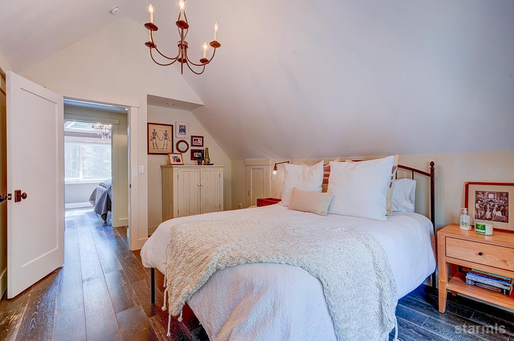 742 Kiowa Drive South Lake Tahoe, CA 96150 - Photo 22 of 26 a bedroom with a bed and wooden floor