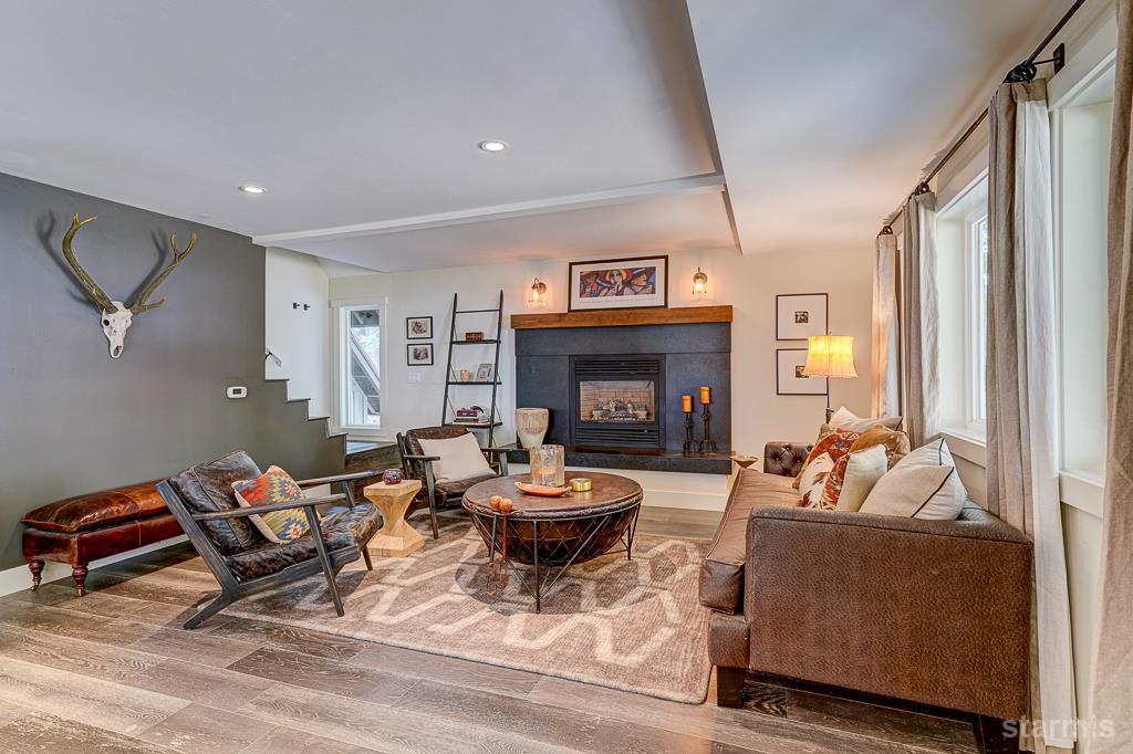 742 Kiowa Drive South Lake Tahoe, CA 96150 - Photo 6 of 26 a living room with furniture a fireplace and a large window